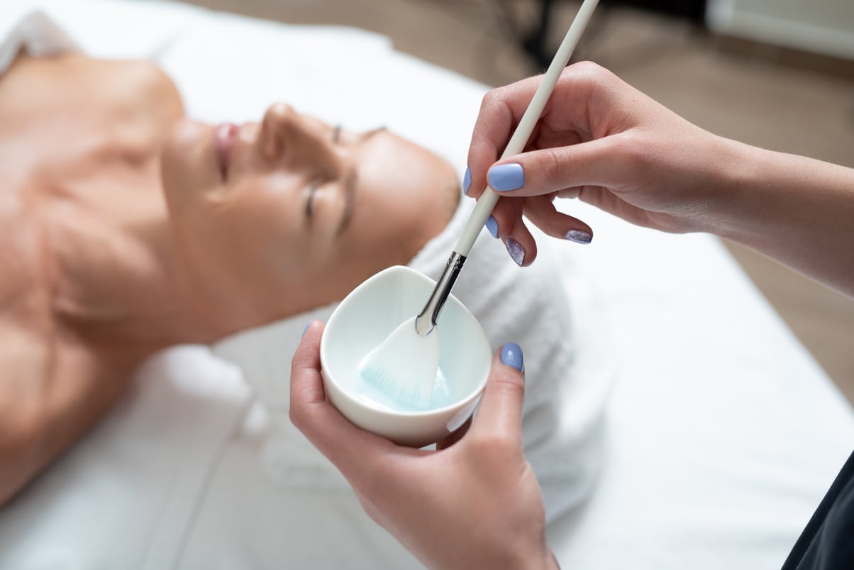 Beautician preparing skincare mask for skincare procedure